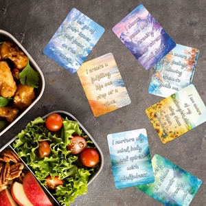 Macro view of watercolor motivational cards with inspirational quotes on stone surface