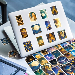 Detail of vintage cosmic starry sky stickers on a white laptop with midnight blue tones