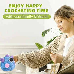 Close-up of hand-crocheting a blue monster plush toy in a cozy home setting