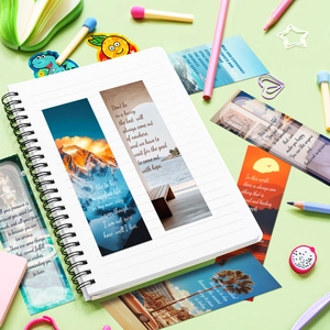 Detail of inspirational landscape bookmarks set in a white spiral notebook with stationery