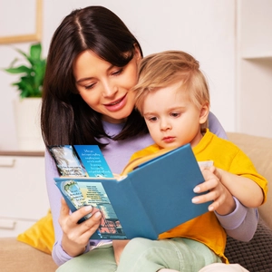 Close-up of lifestyle scene showing a woman and child reading a scenic inspirational book