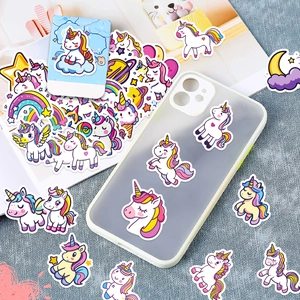 Close-up of waterproof rainbow unicorn stickers decorated on a blue mobile phone case