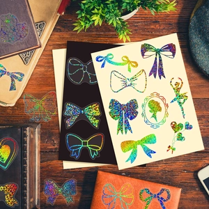 Holographic PET stickers set with bows and heart motifs on a wooden background