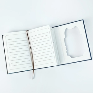 Macro shot of a creative notebook featuring a hidden compartment and a silk ribbon bookmark