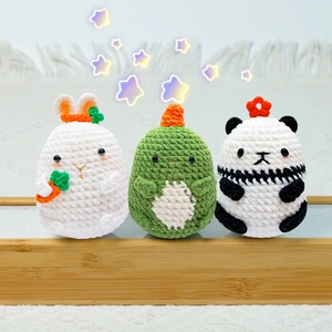 Three-piece crochet animal kit featuring a bunny, dinosaur, and panda made from chenille yarn