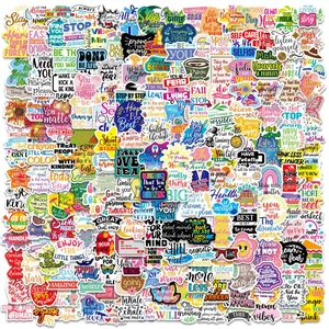 Close-up of colorful inspirational stickers with handwritten motivational English phrases