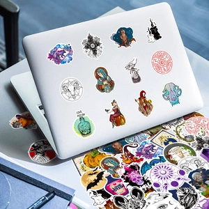50pcs gothic magic stickers showing fantasy wizard themes on a silver laptop