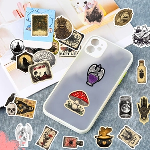 Detail of vintage apothecary stickers with gothic motifs on a clear phone case