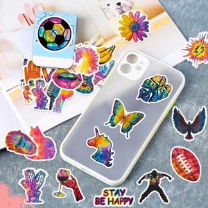 Close-up of vibrant graffiti stickers with butterfly and unicorn art on a phone case