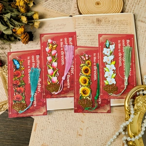 Vintage hollow metal bookmarks with floral themes, colorful tassels on decorative paper