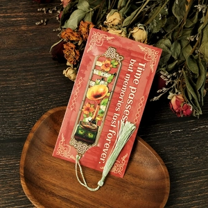 Detail of vintage phonograph metal bookmark with green tassel on red gift card