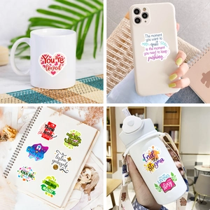 Close-up of inspirational quotes stickers used on mugs and phone cases for decoration