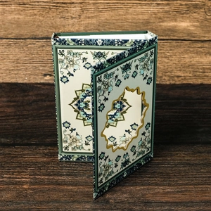 Close-up of vintage floral notebook with hollow-carved cover and magnetic closure