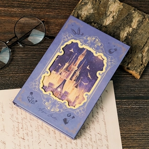 Dreamy magic castle theme hardcover notebook with golden frame on vintage wood table