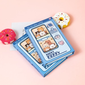 Detail of two blue notebooks with cute cartoon dog illustrations and hollowed-out covers