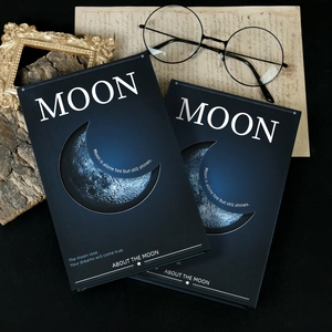 Detail of matte black moon diary featuring celestial patterns and motivational text