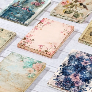 Vintage aesthetic scrapbook paper with butterfly, floral and bird art on wood surface