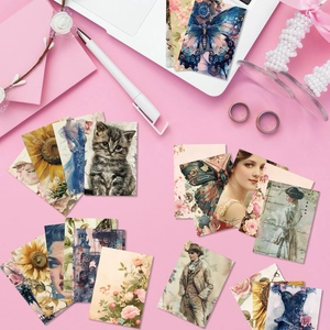 Flat lay of vintage scrapbooking paper with butterflies, florals and cats on pink desk