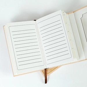 Close-up of minimalist lined inner pages and dark brown ribbon bookmark of the notebook