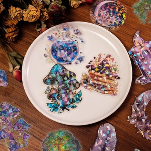 Close-up of holographic fantasy stickers with laser aurora finish on a white plate