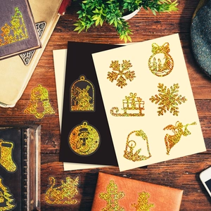 Detailed holographic gold laser Christmas stickers with snowflakes and reindeer motifs