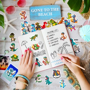 Vibrant cartoon dinosaur stickers displayed on a notebook with summer vacation theme props