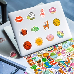 Set of 100 cute cartoon PVC stickers with vibrant colors on a laptop cover