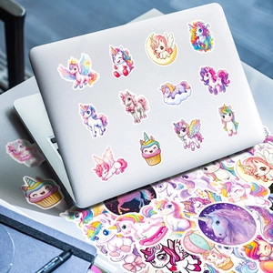 Macro shot of colorful unicorn stickers applied to a laptop with various dreamlike designs