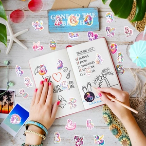 Dreamy unicorn stickers set on a summer beach themed desk with decorative props