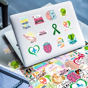 Waterproof mental health stickers displayed on a laptop with inspirational quotes and graphics