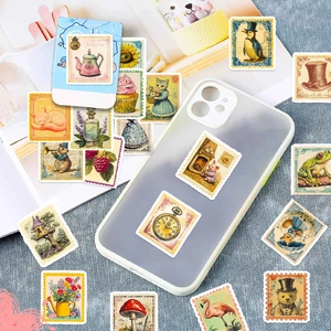 Vintage stamp-style stickers with animal illustrations on notebook and blue fabric background