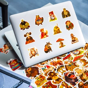Close-up of cute fairy tale stickers with animals and mushrooms on a white laptop lid