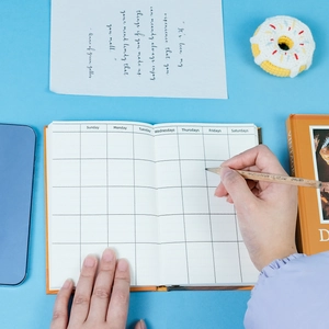 Detailed view of the monthly planner layout with grid pages and lifestyle accessories