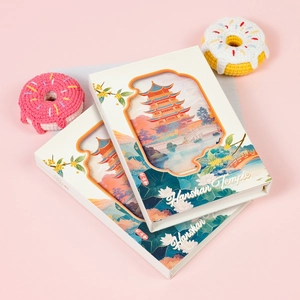 Detailed view of layered paper-cut art featuring Hanshan Temple on a tri-fold notebook
