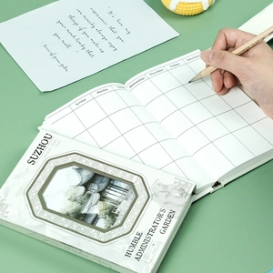 Detail of Chinese garden theme notebook showing monthly planner grids and hollow design