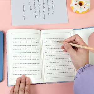 Close-up of dotted inner pages on a Mount Fuji notebook with pencil and cherry blossom theme