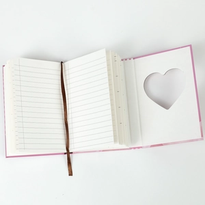Pink hardcover notebook with heart-shaped cutout, lined pages and silk bookmark ribbon