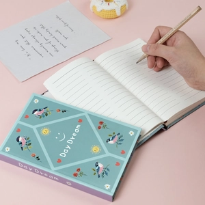 Close-up of Day Dream series journal with hardcover illustration and lined inner pages