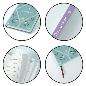Detail of Day Dream notebook showing illustrated cover, ribbon bookmark and lined pages