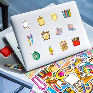 Cartoon stationery stickers applied on a silver laptop showing various creative hand-drawn icons