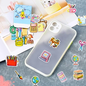 Detail of cute cartoon stationery stickers on a phone case and magazine page