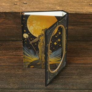 Vintage magic scepter notebook with moon tarot cover on dark wooden desk