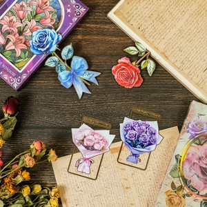 Detailed view of floral metal bookmarks with enamel roses and inspirational quotes