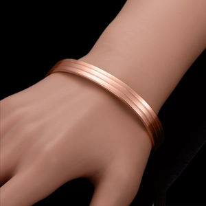 Minimalist 18K rose gold plated magnetic copper bangle with three parallel linear grooves