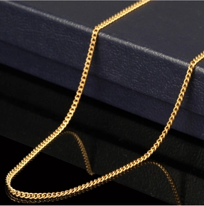 Close-up of 18K gold-plated Figaro chain necklace with a polished metallic finish