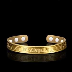 Detail of gold-plated open bangle with Greek key patterns and 6 healing magnets