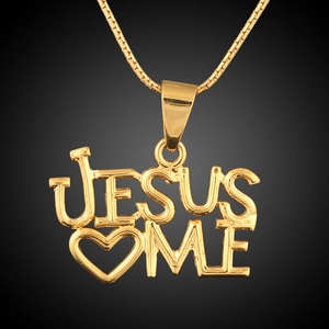 Macro detail of 18K gold plated JESUS ME heart pendant on a sleek snake chain necklace