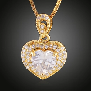 Macro close-up of 18K gold plated heart pendant necklace with shimmering zircon stones