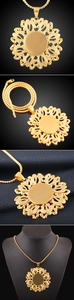 Detail showing 18K gold hollow floral pendant with intricate sandblasted texture
