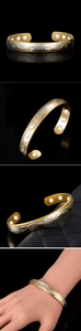 Detail of gold magnetic therapy bracelet featuring silver floral reliefs and magnets